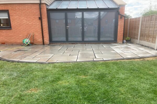 Grey Sandstone Slabbed Patio With Black Grout And French Gravel Drains In Hamstead 6.jpeg